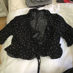 Black polka dotted wrap top with ruffles